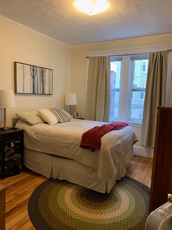 16 Royce Road, Unit 5 Boston, MA 02134 - Photo 5 of 10 a bedroom with a bed and wooden floor