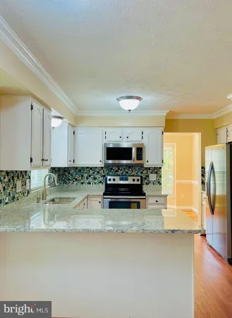 a kitchen with stainless steel appliances granite countertop a stove and a sink