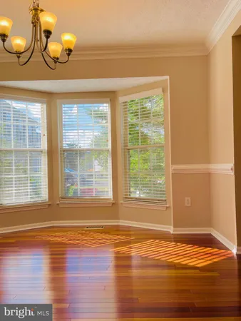 a view of a room with wooden floor and window