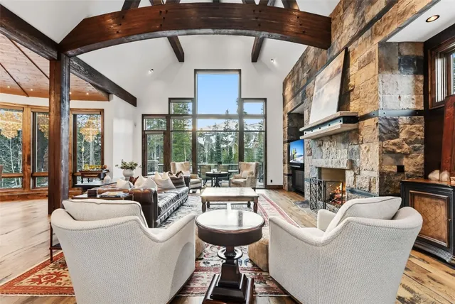 a living room with fireplace furniture and a large window