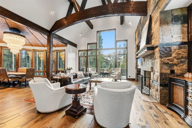 a living room with fireplace furniture and a large window