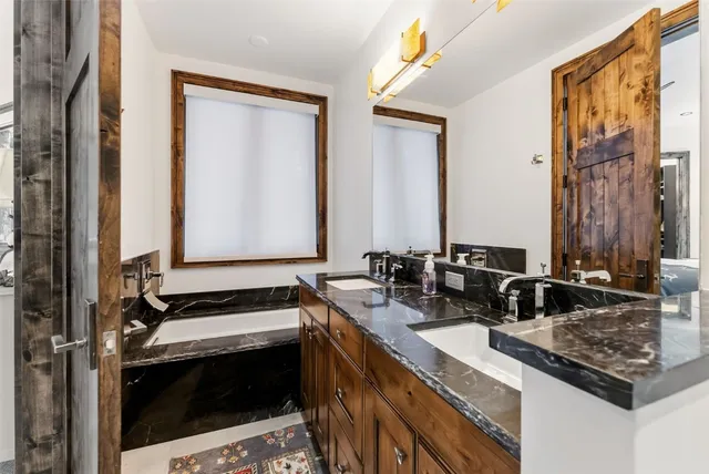 a kitchen with sink stove and cabinets