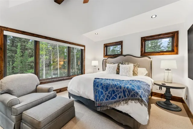 a bedroom with a bed and a large window