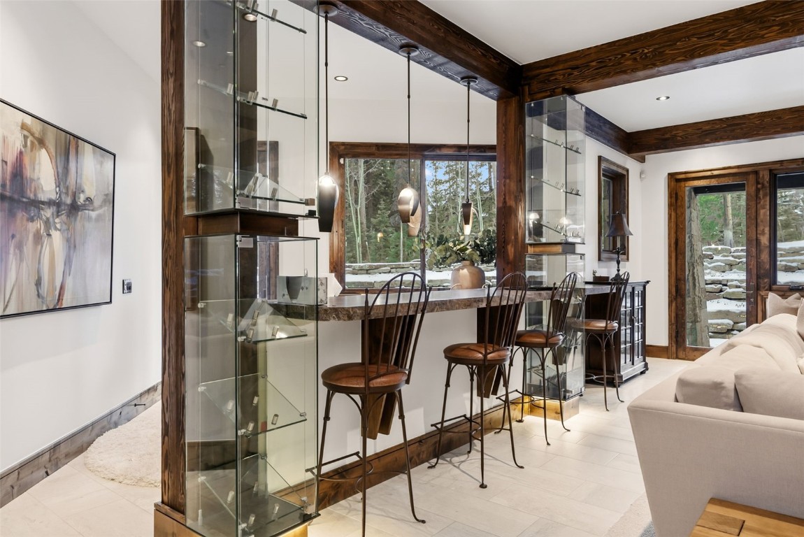 111 Brooks Snider Road Breckenridge, CO 80424 - Photo 40 of 44 a kitchen with stainless steel appliances kitchen island granite countertop a refrigerator a stove a dining table and chairs with wooden floor