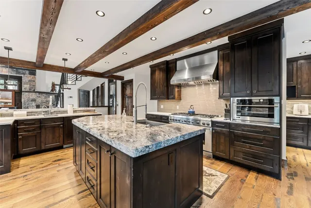 a kitchen with stainless steel appliances granite countertop a stove and a sink