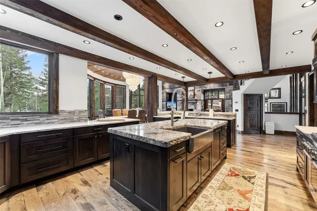 a kitchen with stainless steel appliances granite countertop a sink and a large counter space