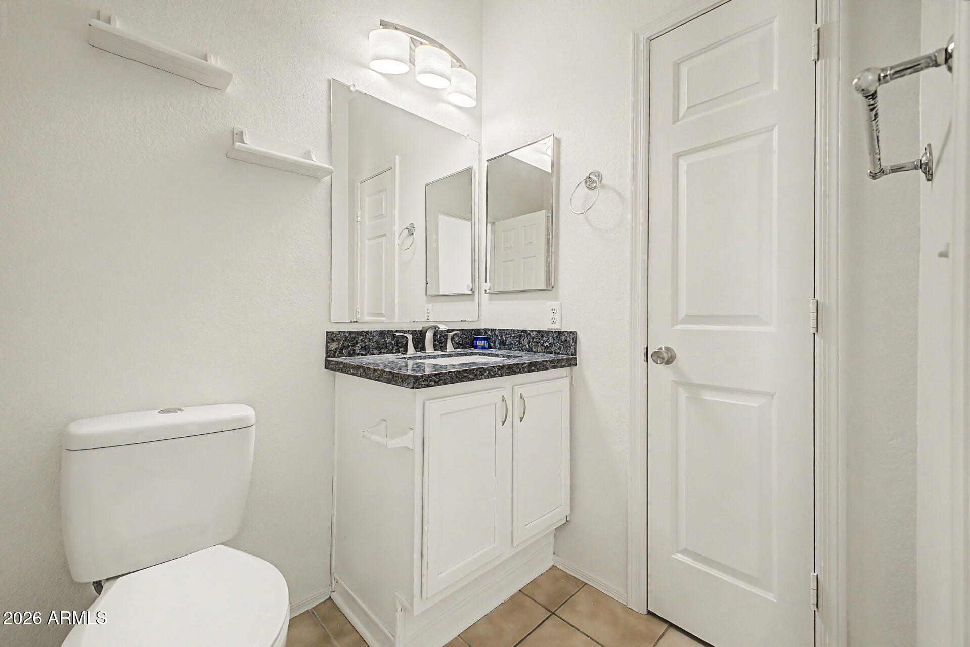 13261 West Redfield Road Surprise, AZ 85379 - Photo 13 of 36 a bathroom with a toilet a sink and shower