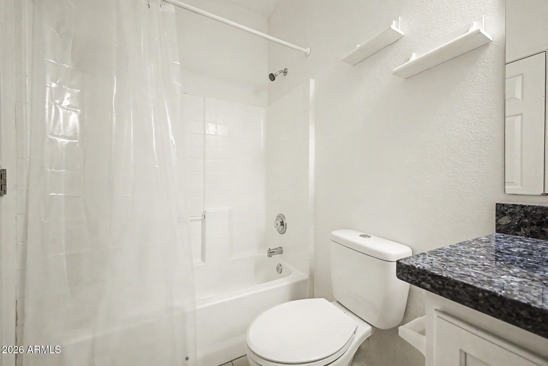 13261 West Redfield Road Surprise, AZ 85379 - Photo 21 of 36 a white toilet sitting next to a bathroom sink