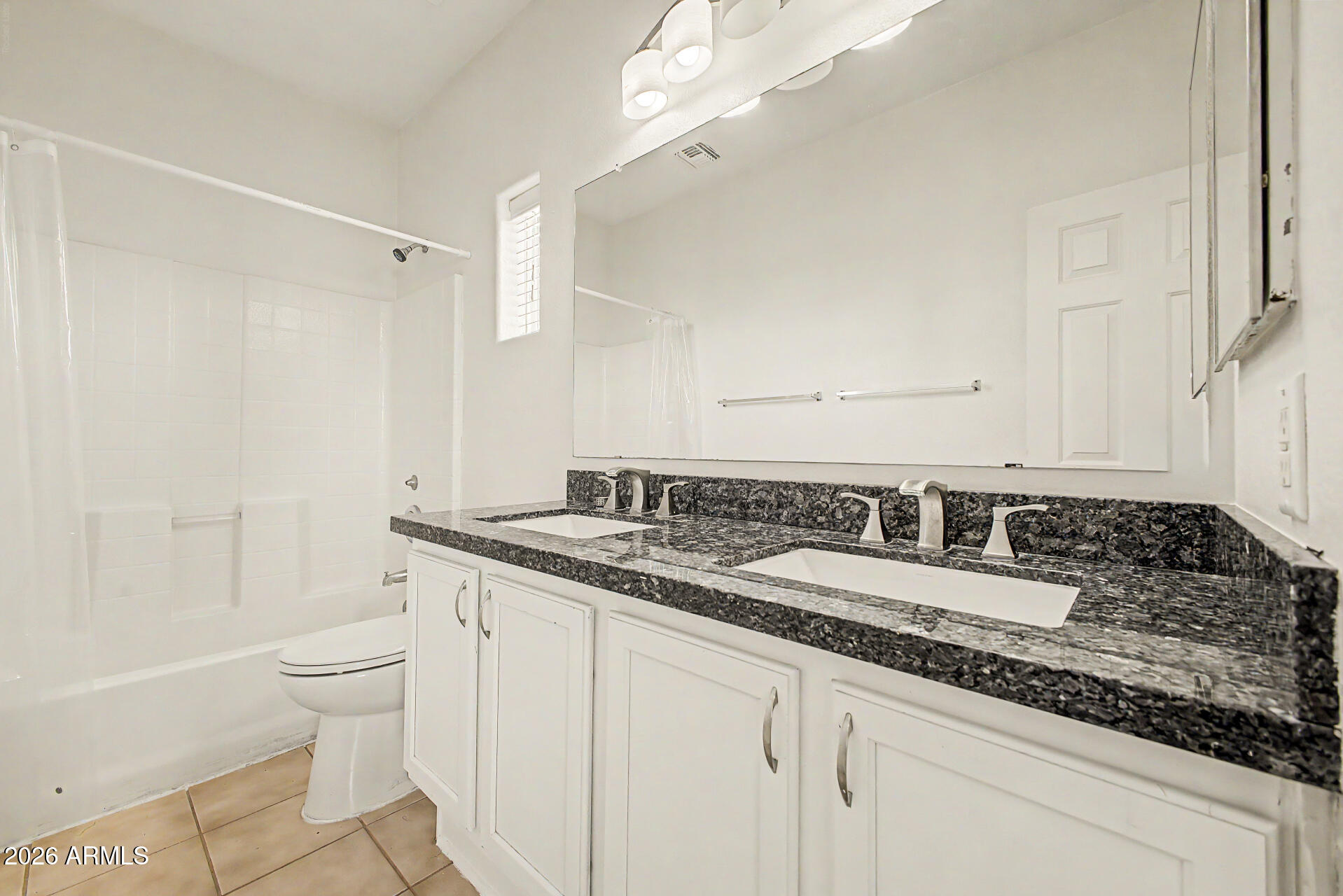 13261 West Redfield Road Surprise, AZ 85379 - Photo 24 of 36 a bathroom with a granite countertop sink a toilet and a bathtub