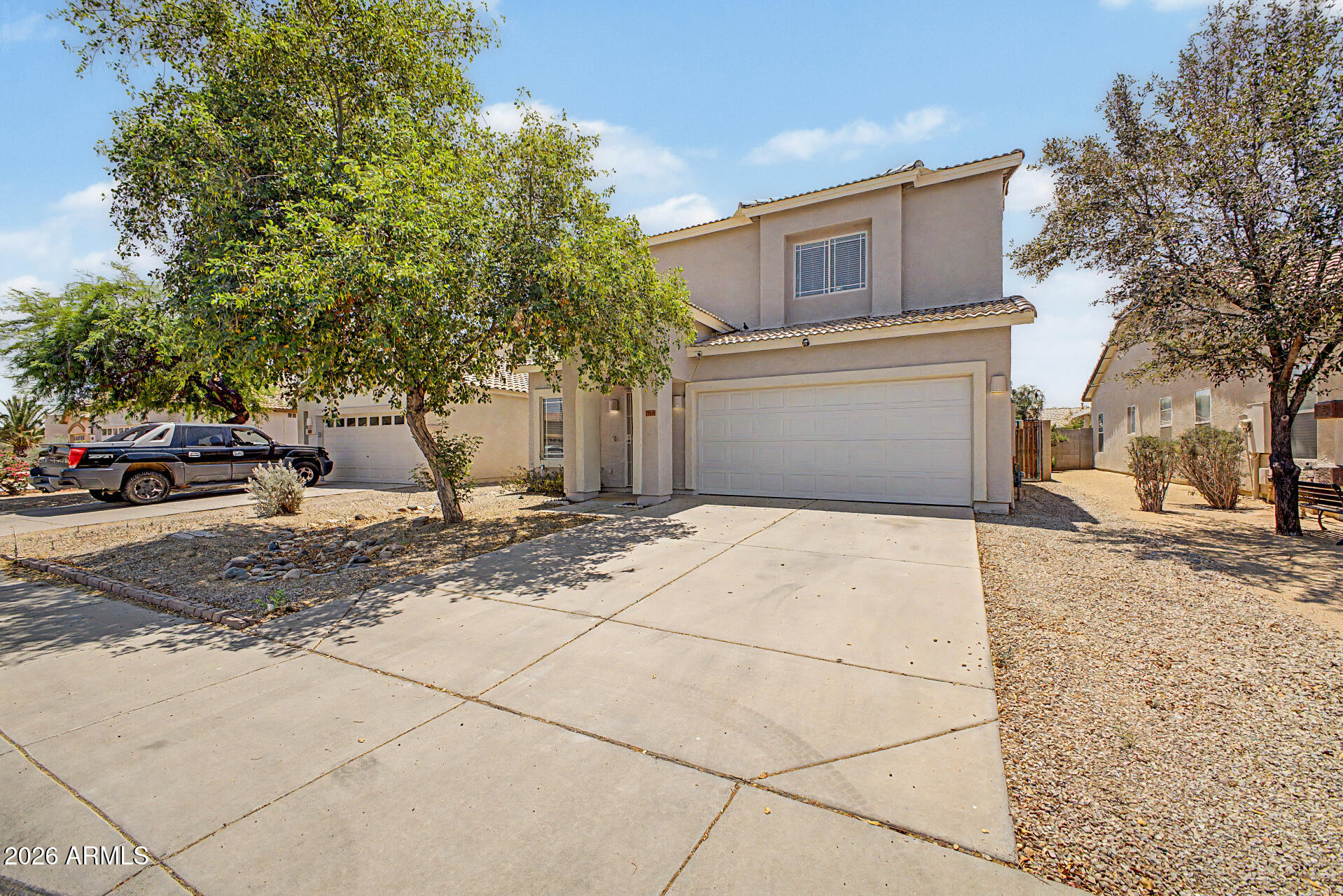 13261 West Redfield Road Surprise, AZ 85379 - Photo 3 of 36 a front view of a house with a yard and garage