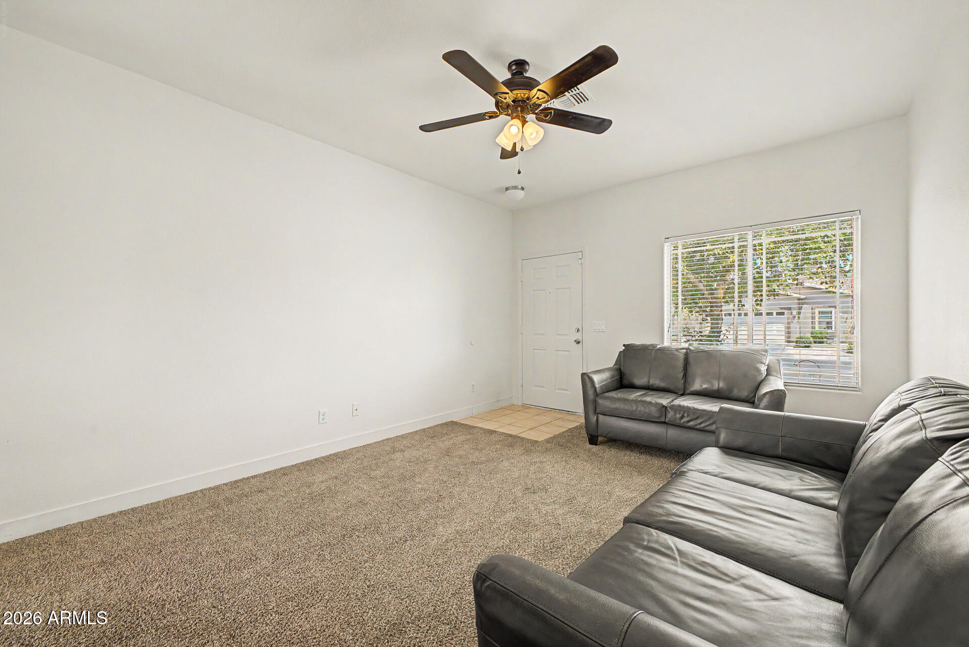 13261 West Redfield Road Surprise, AZ 85379 - Photo 4 of 36 a living room with furniture and a large window
