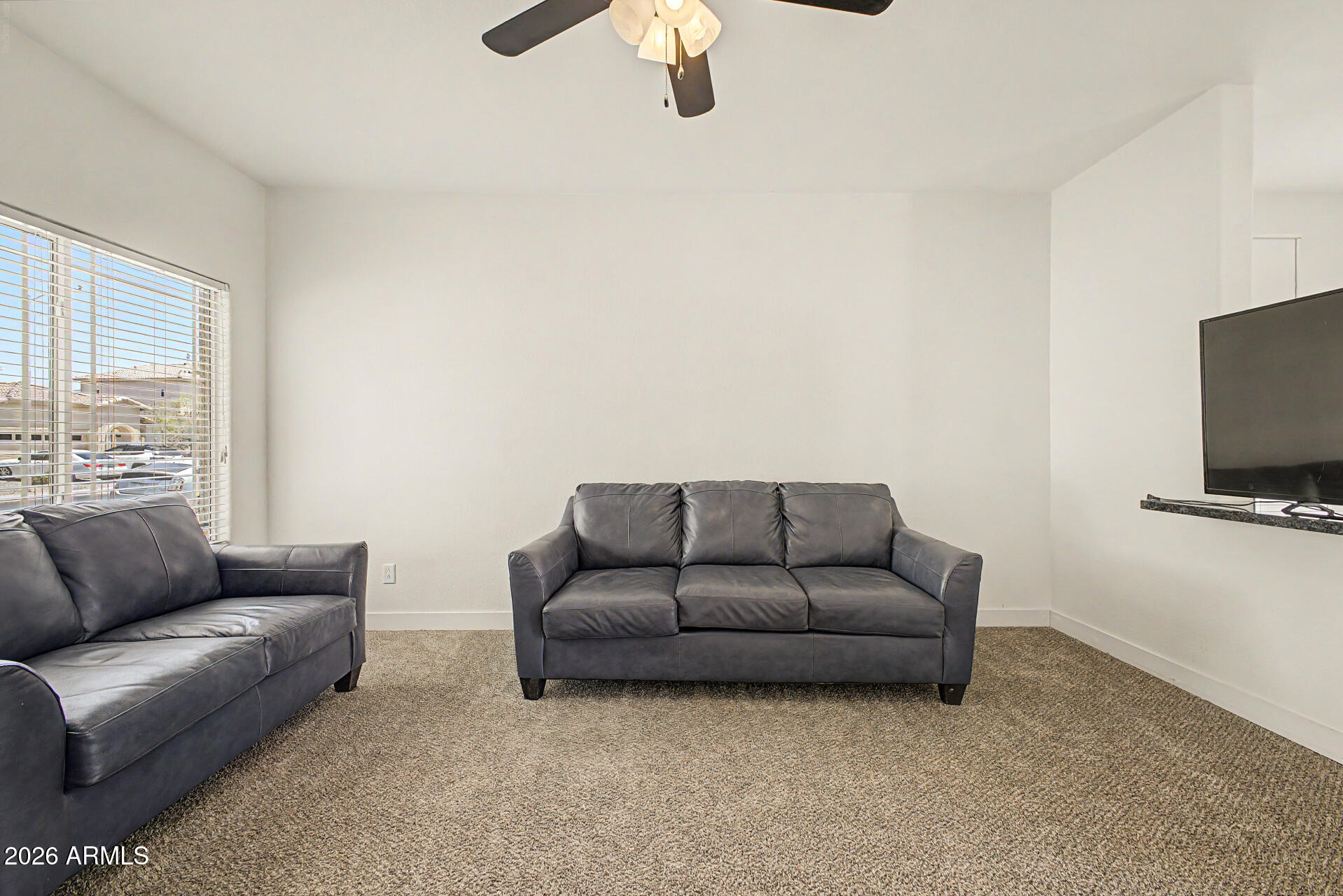 13261 West Redfield Road Surprise, AZ 85379 - Photo 5 of 36 a living room with furniture a couch and a flat screen tv