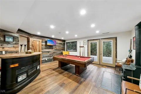 a living room with fireplace furniture and a wooden floor