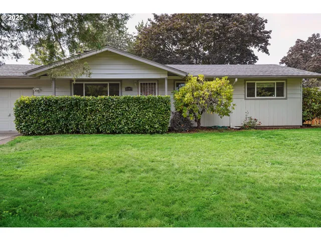 a front view of a house with a garden