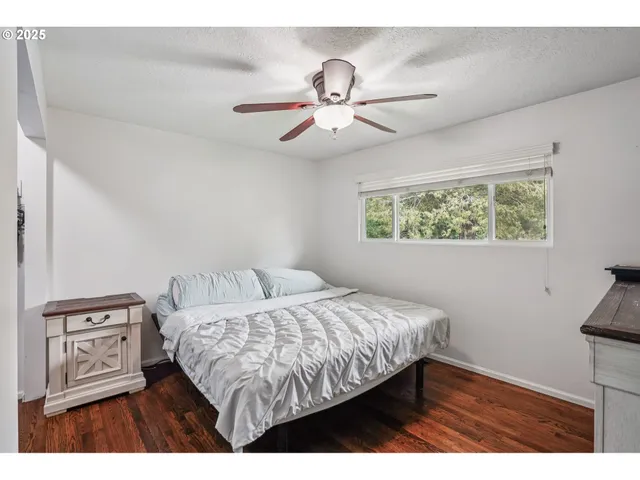 a bedroom with a bed and a tv