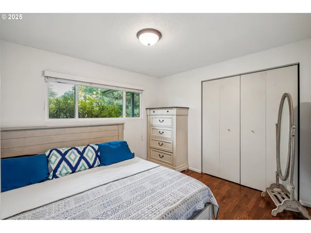 a bedroom with a bed and a dresser