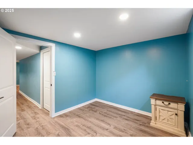a view of a room with wooden floor