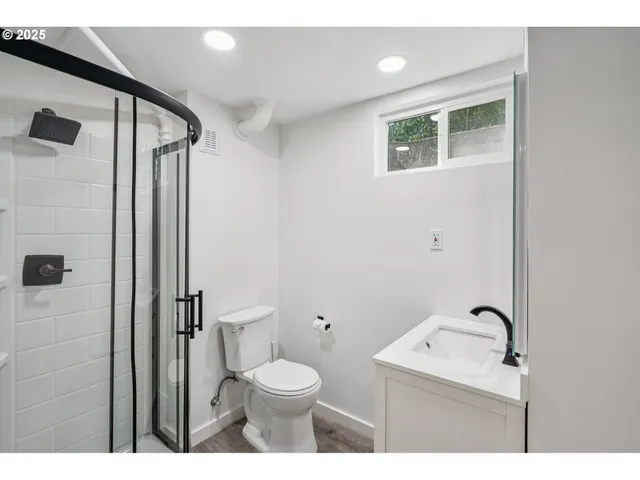 a bathroom with a toilet a sink and mirror