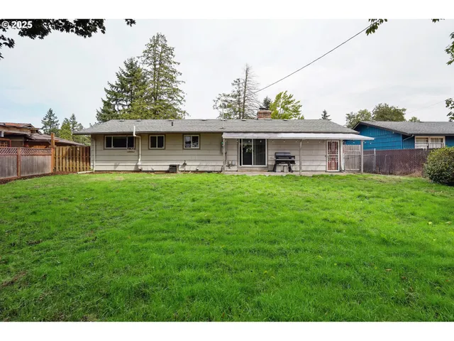 a view of a house with a yard and sitting area