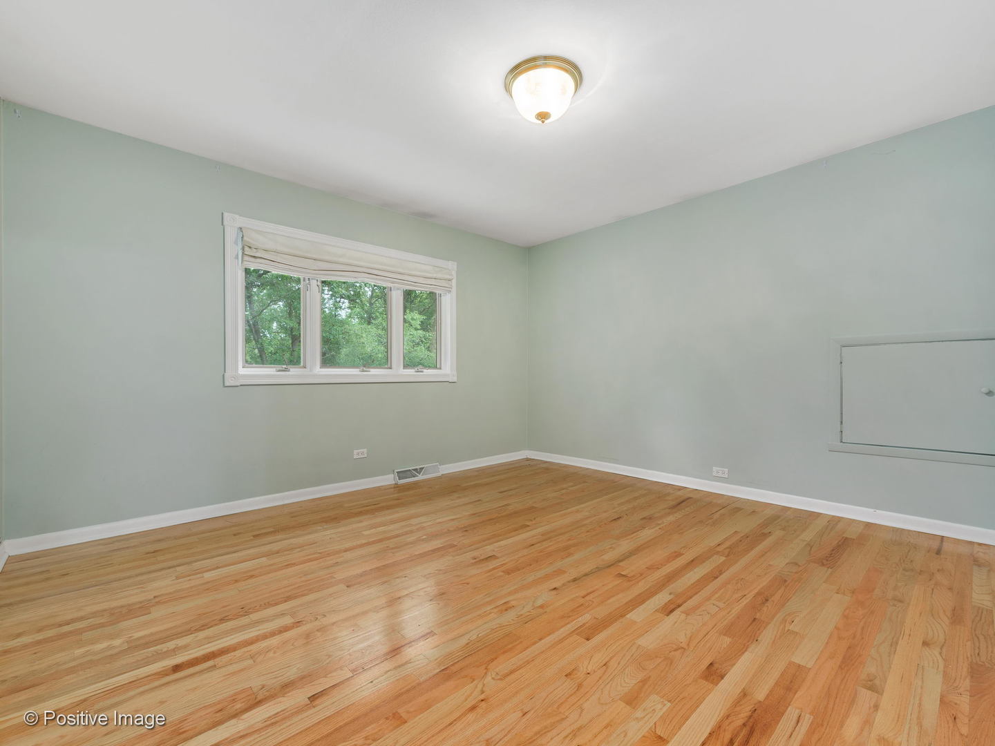 757 Ridge Road Highland Park, IL 60035 - Photo 16 of 26 an empty room with wooden floor and windows