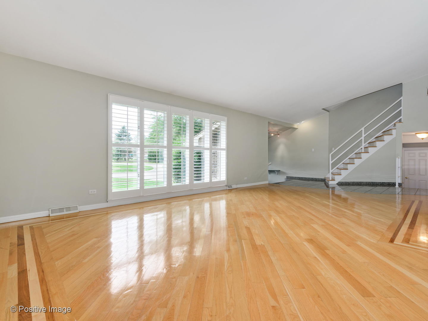 757 Ridge Road Highland Park, IL 60035 - Photo 3 of 26 a view of an empty room with a window and wooden floor