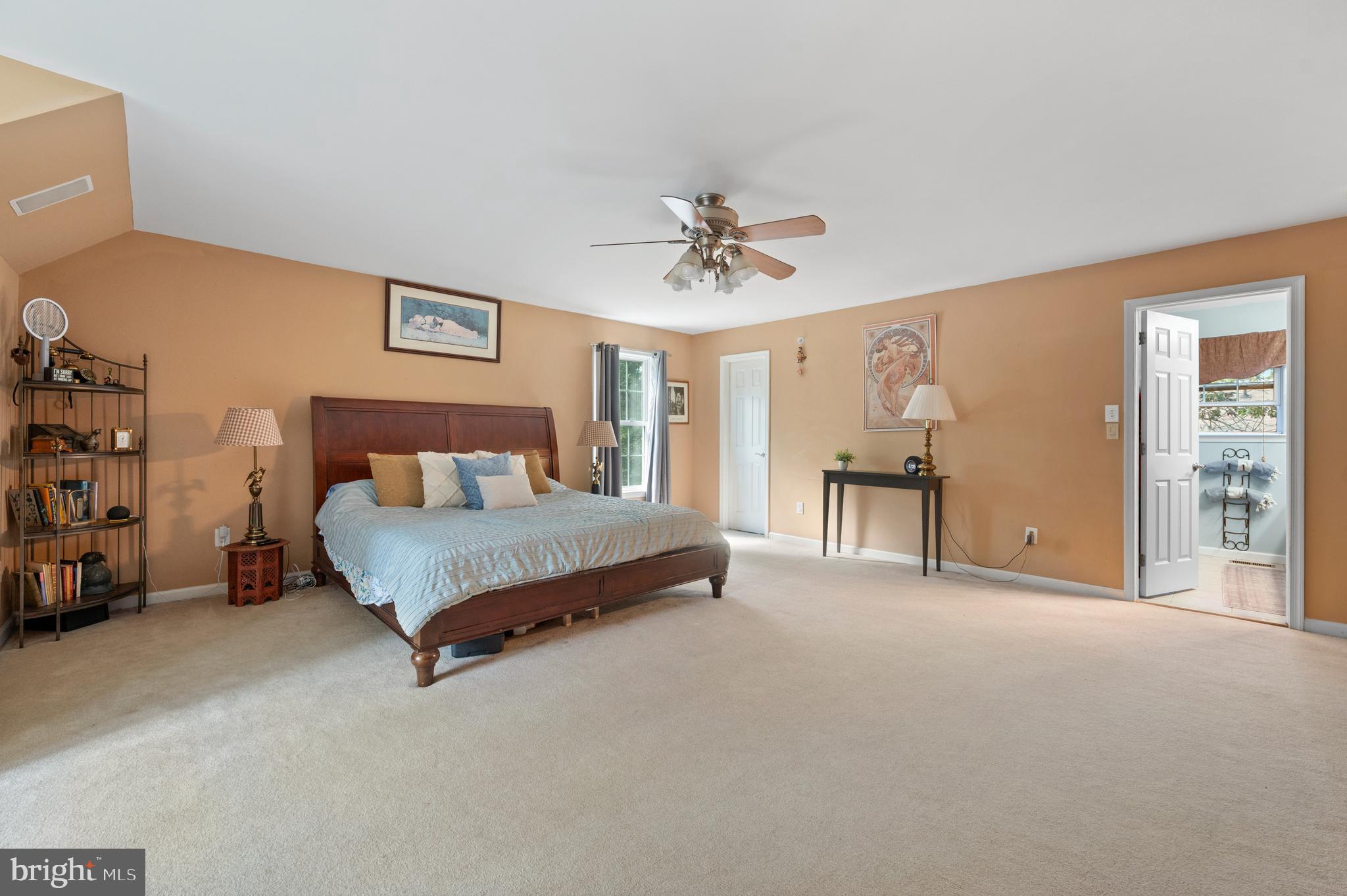210 Main Street Newtown Square, PA 19073 - Photo 20 of 43 a spacious bedroom with a bed and a chandelier
