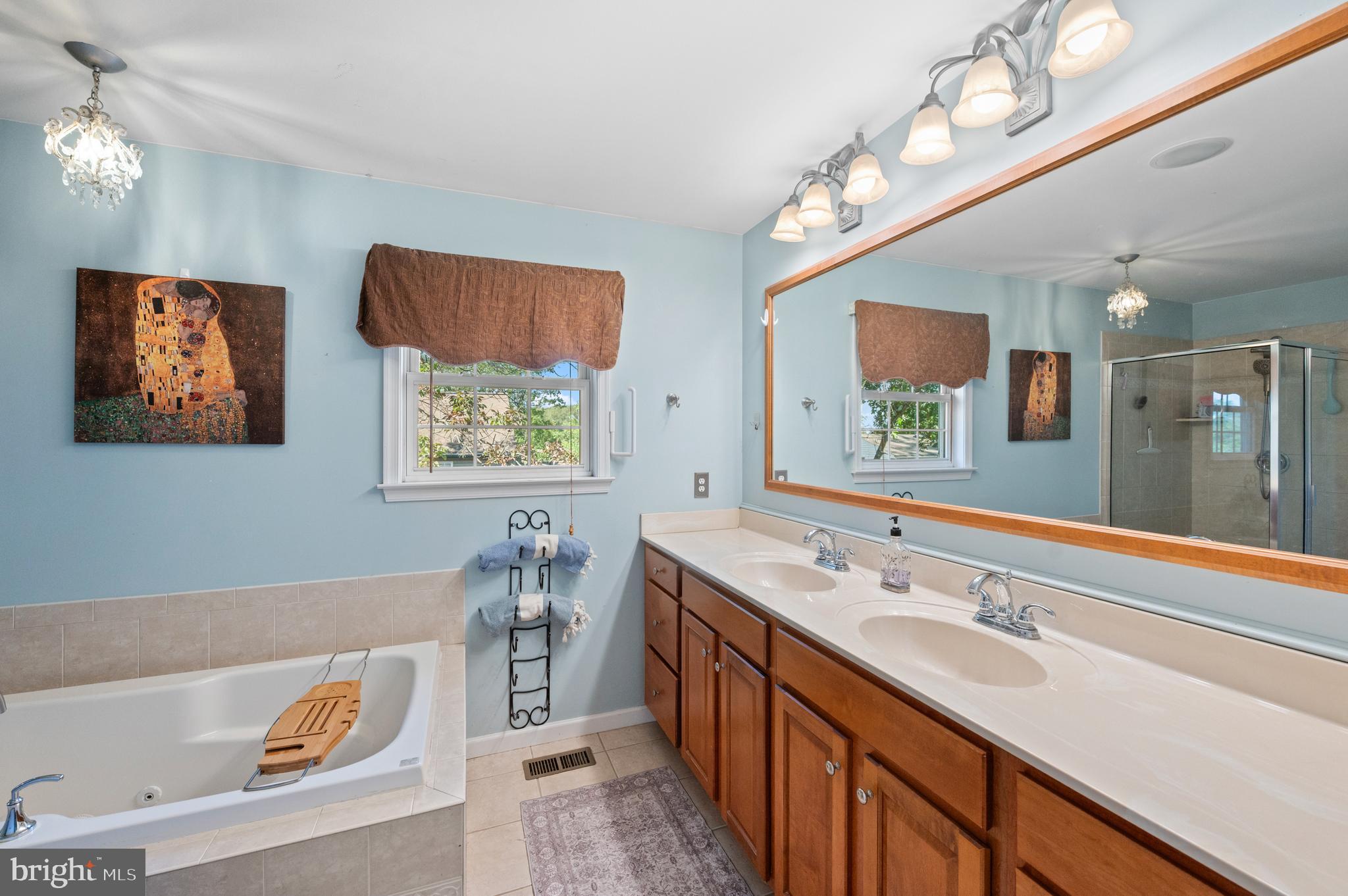 210 Main Street Newtown Square, PA 19073 - Photo 23 of 43 a spacious bathroom with a sink a large mirror and a bathtub