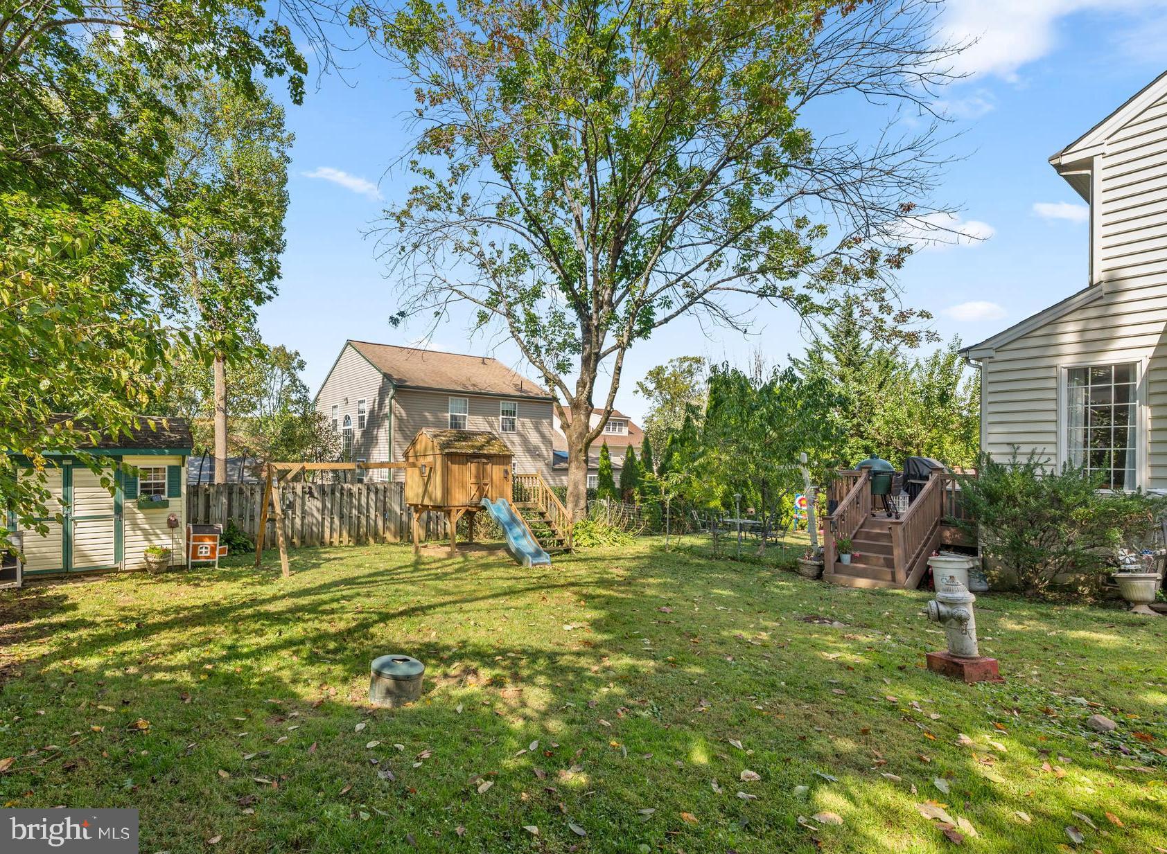 210 Main Street Newtown Square, PA 19073 - Photo 43 of 43 a backyard of a house with lots of green space and fountain