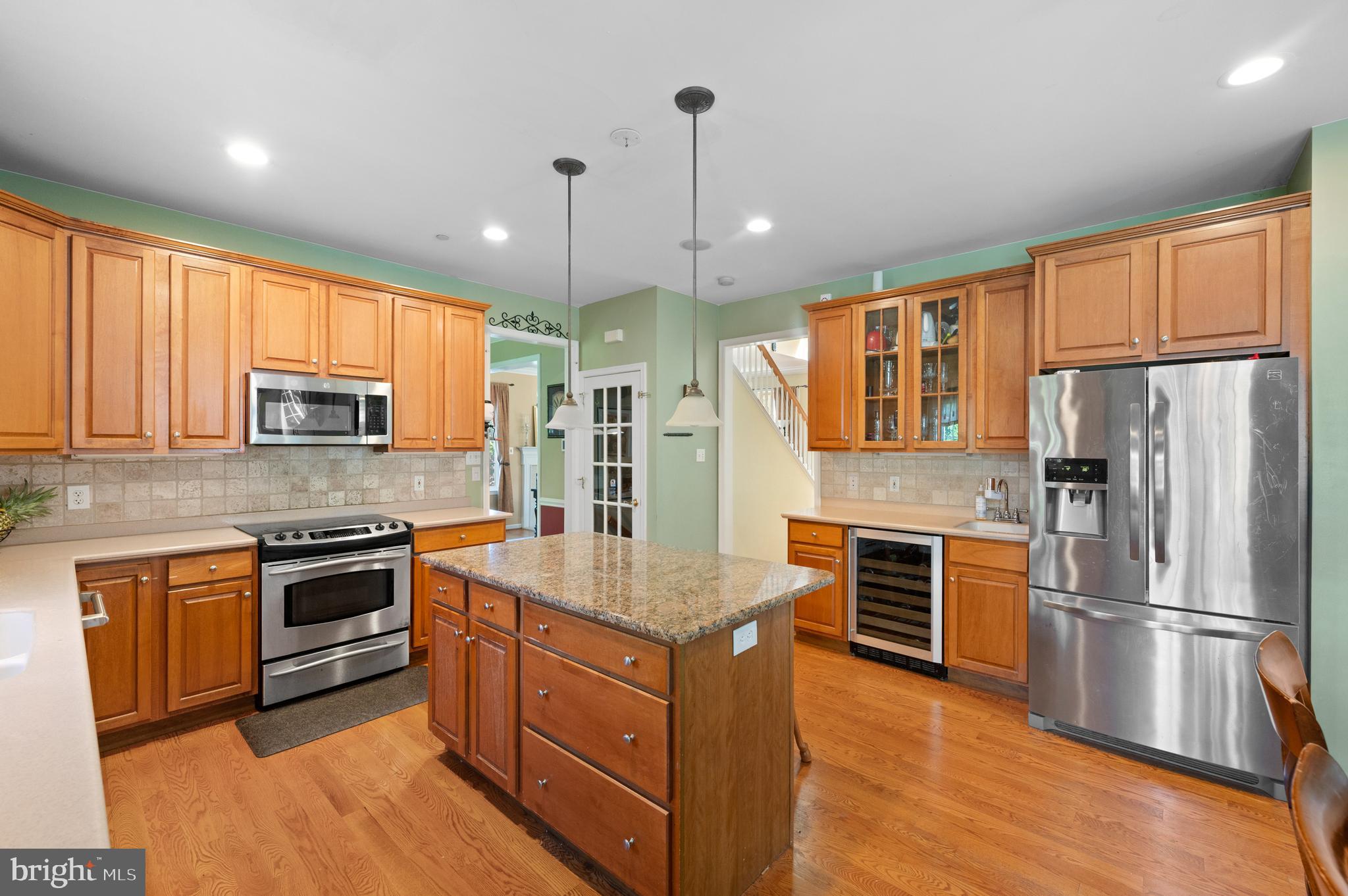 210 Main Street Newtown Square, PA 19073 - Photo 5 of 43 a kitchen with granite countertop stainless steel appliances and wooden cabinets