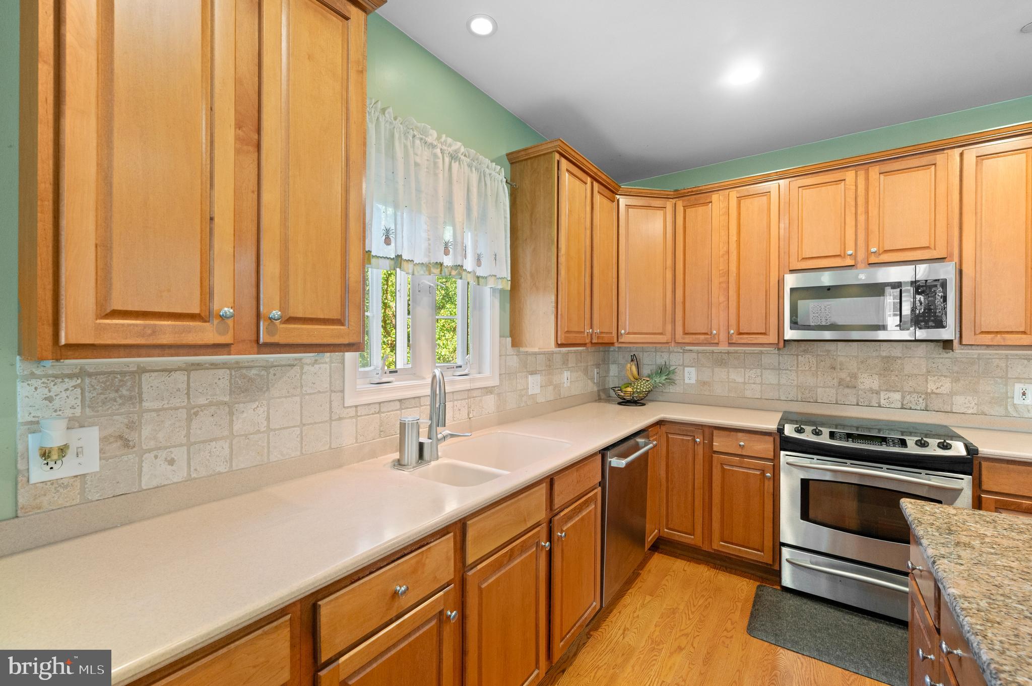 210 Main Street Newtown Square, PA 19073 - Photo 6 of 43 a kitchen with stainless steel appliances a sink stove and cabinets