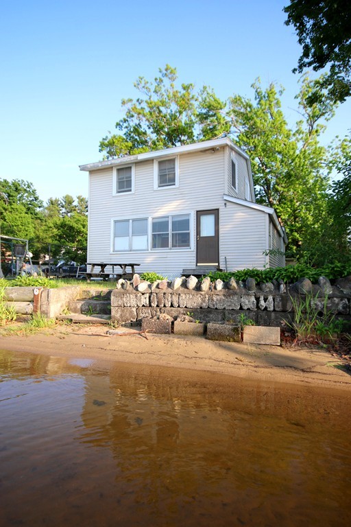 1 Bisson Lane Merrimac, MA 01860 - Photo 2 of 30 a front view of a house with yard and trees in the background