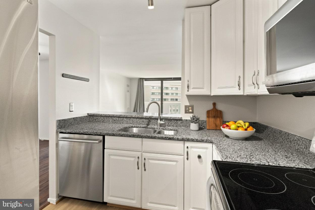 6101 Edsall Road, Unit 1209 Alexandria, VA 22304 - Photo 11 of 35 a kitchen with stainless steel appliances granite countertop a sink stove and cabinets