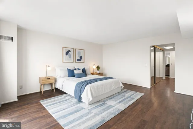 a bed room with a bed and painting on the wall