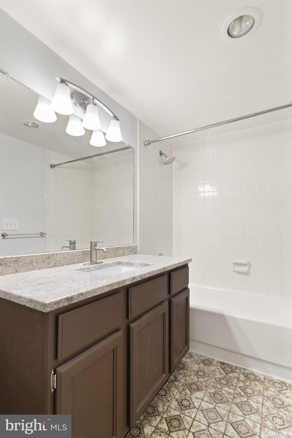 6101 Edsall Road, Unit 1209 Alexandria, VA 22304 - Photo 18 of 35 a bathroom with a sink a vanity and a mirror