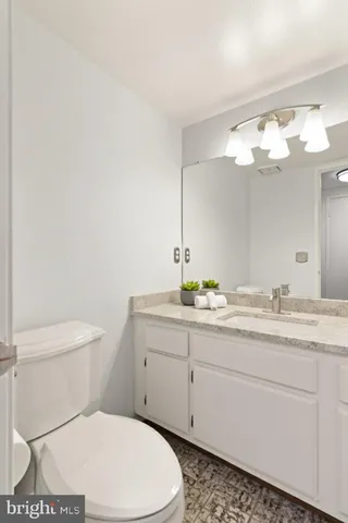 a bathroom with a toilet a sink and mirror