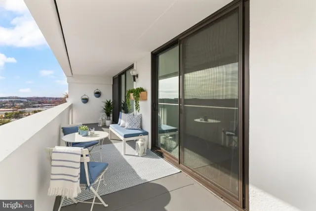 a dining room with furniture and a floor to ceiling window