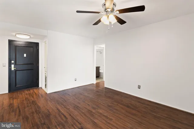 a view of an empty room with wooden floor