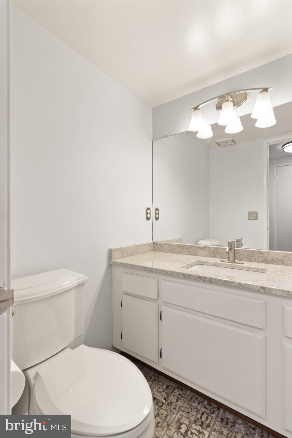 6101 Edsall Road, Unit 1209 Alexandria, VA 22304 - Photo 29 of 35 a bathroom with a toilet sink and mirror