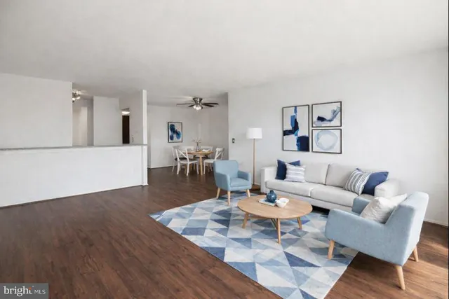 a dining room with wooden floor and white walls