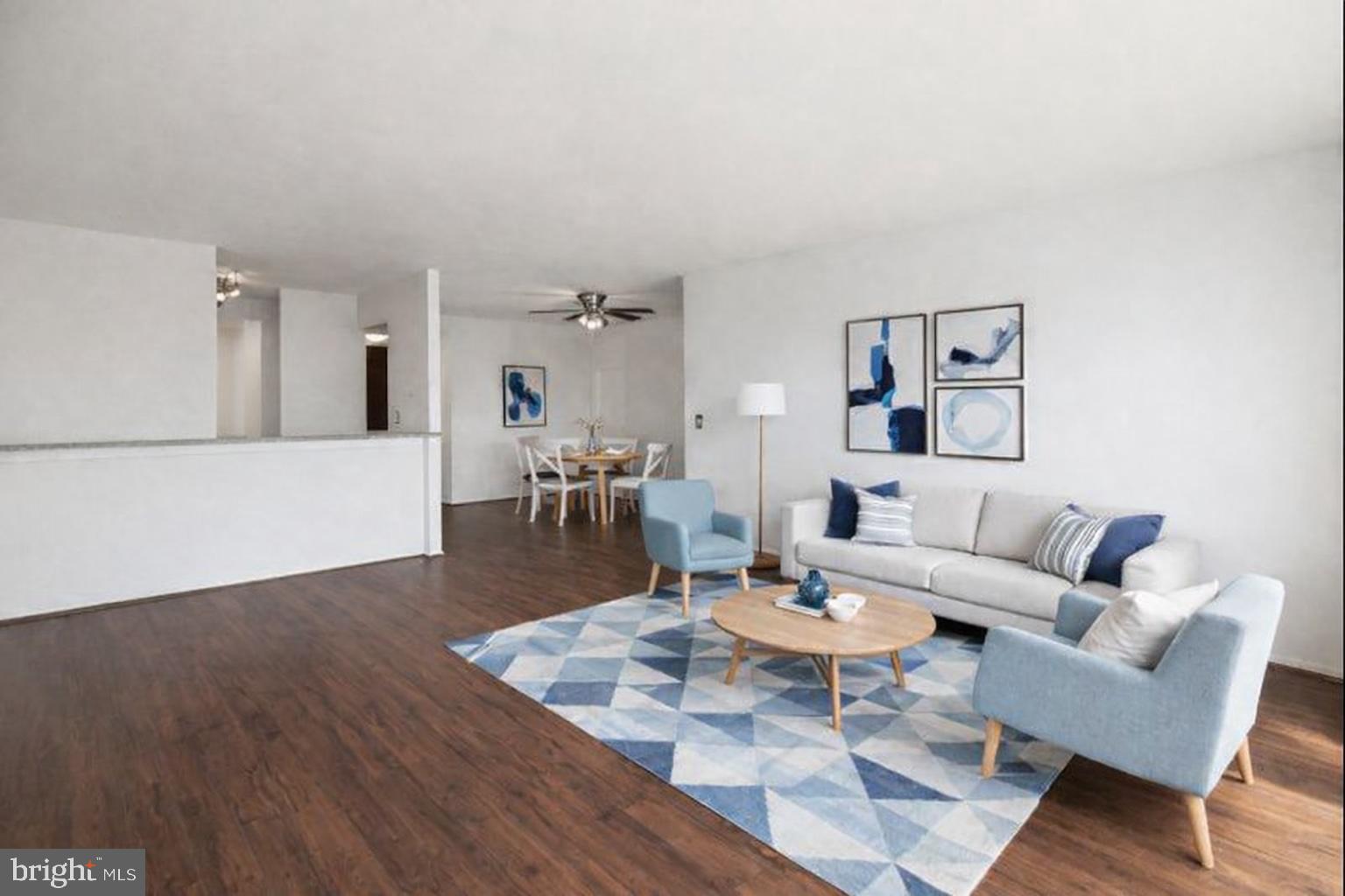 6101 Edsall Road, Unit 1209 Alexandria, VA 22304 - Photo 3 of 35 a dining room with wooden floor and white walls