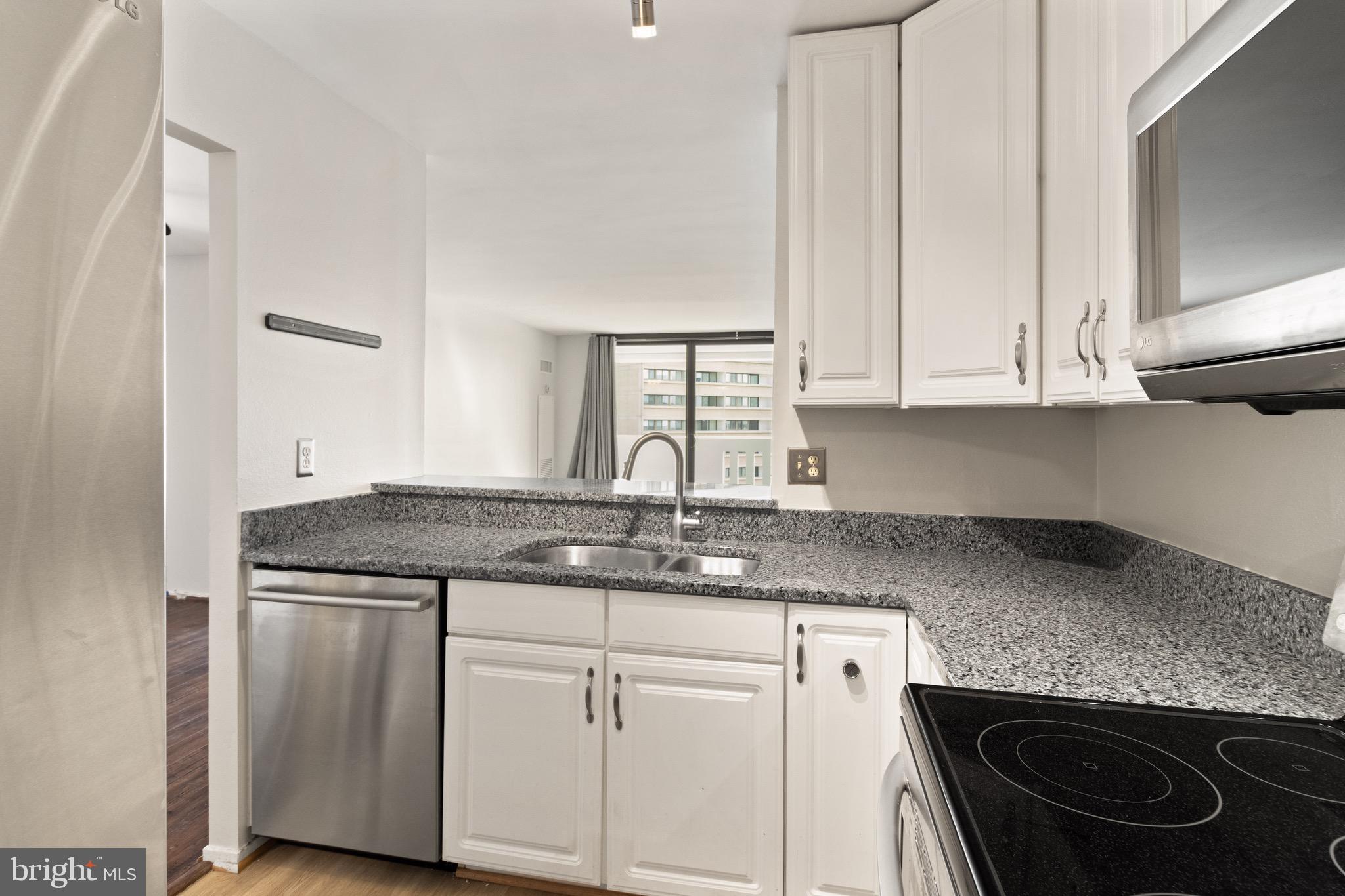 6101 Edsall Road, Unit 1209 Alexandria, VA 22304 - Photo 32 of 35 a kitchen with stainless steel appliances granite countertop a sink stove and cabinets