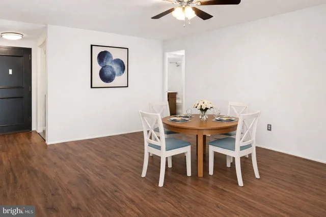 a dining room with furniture a chandelier and wooden floor