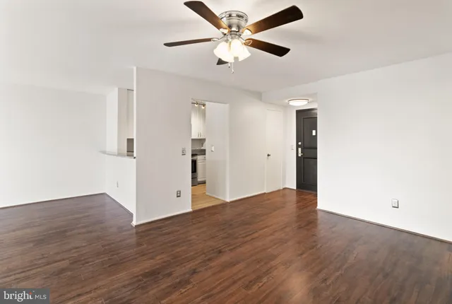 a view of an empty room with wooden floor
