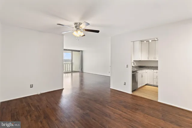 a view of a room with wooden floor and window
