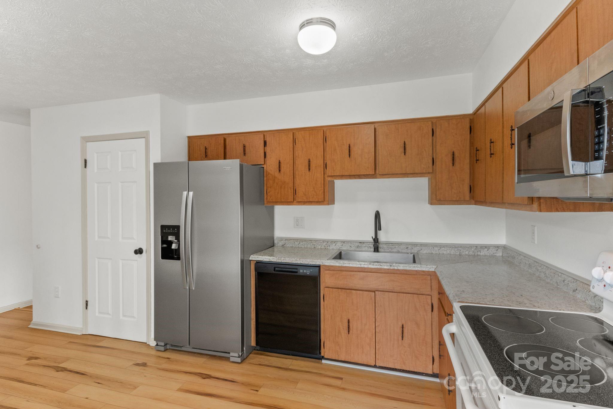 14 South Ridge Place Arden, NC 28704 - Photo 11 of 32 a kitchen with stainless steel appliances granite countertop a sink stove and refrigerator
