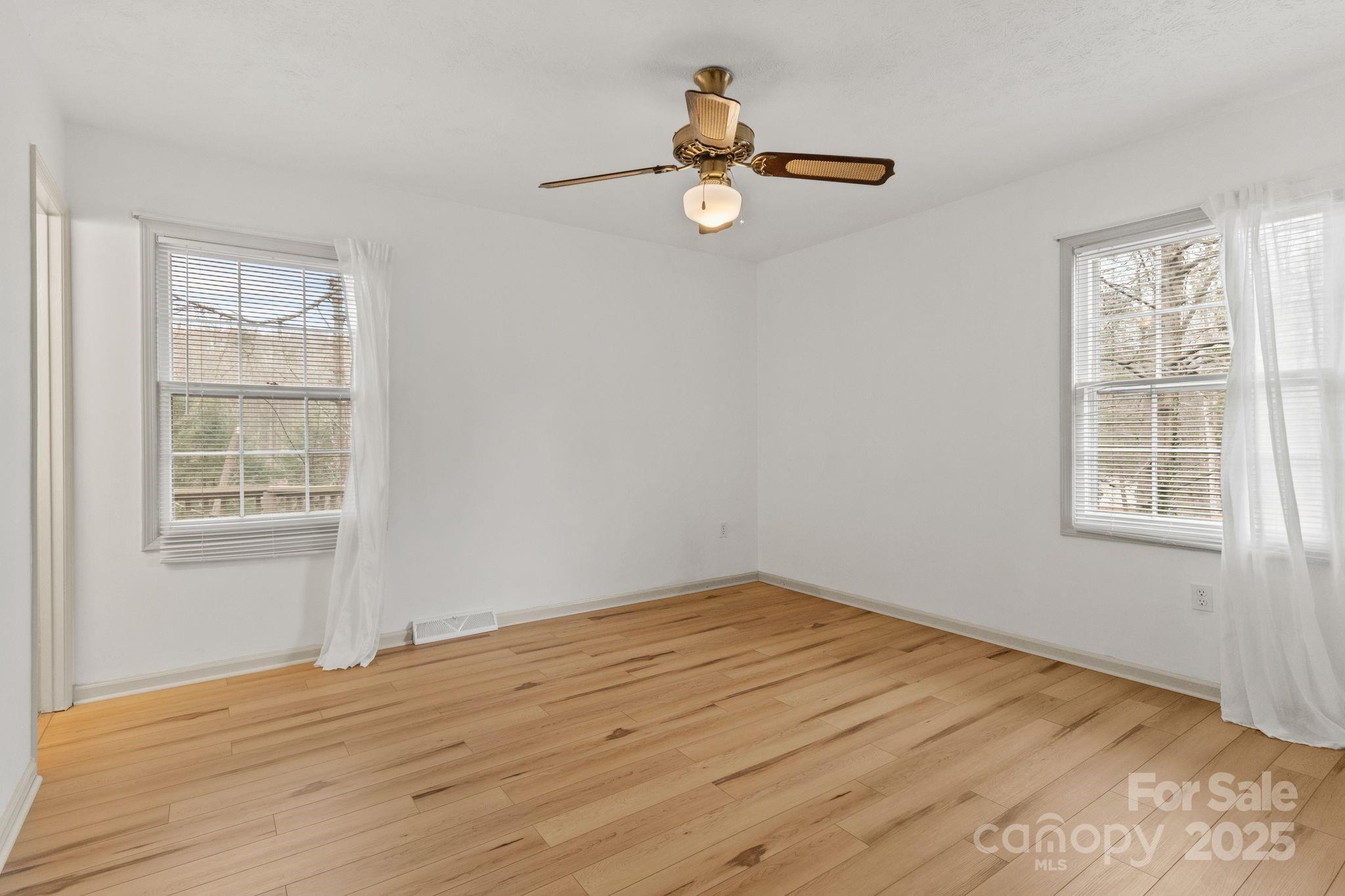 14 South Ridge Place Arden, NC 28704 - Photo 20 of 32 a view of empty room with wooden floor and fan