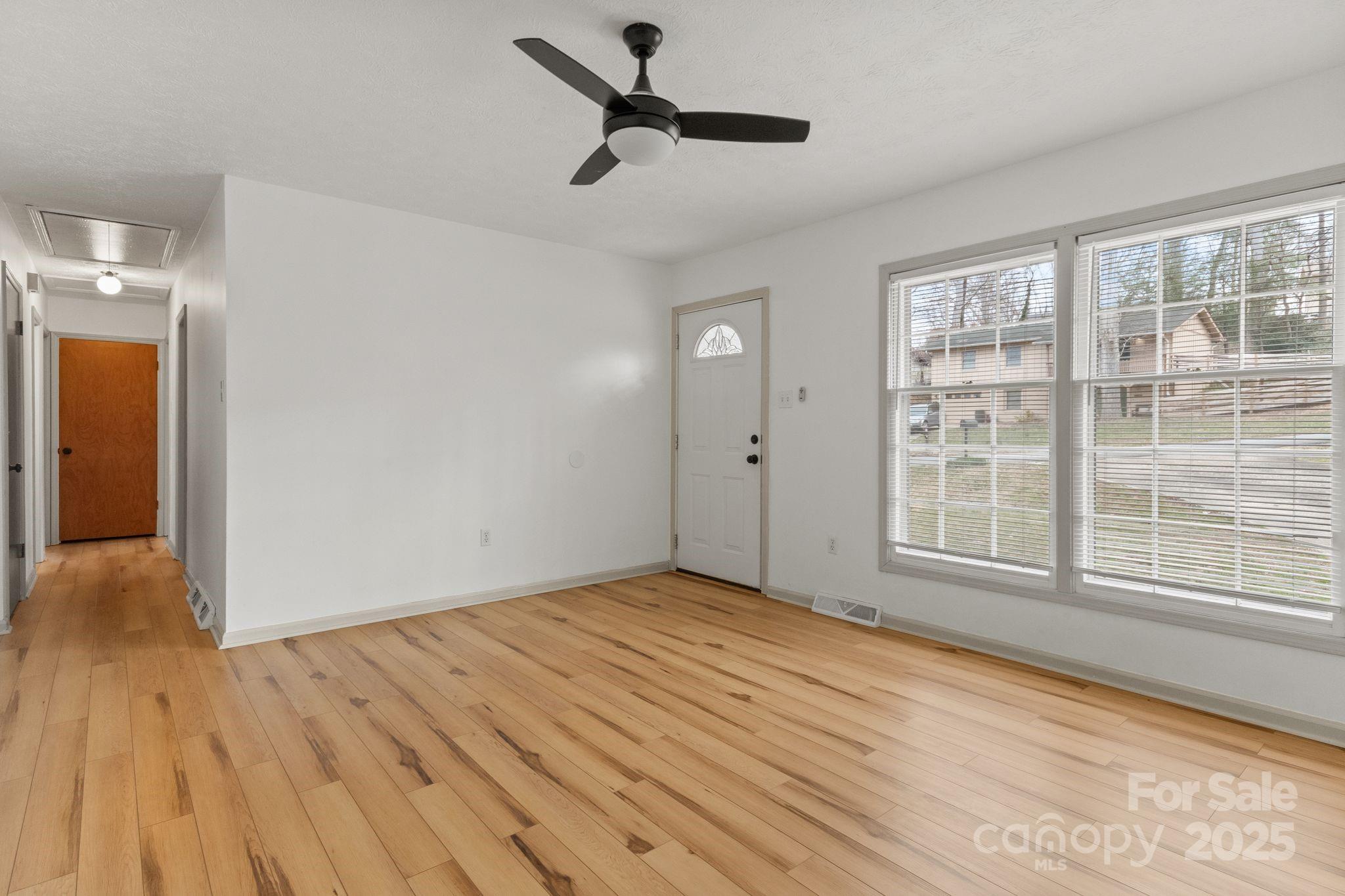 14 South Ridge Place Arden, NC 28704 - Photo 4 of 32 a view of empty room with wooden floor and fan