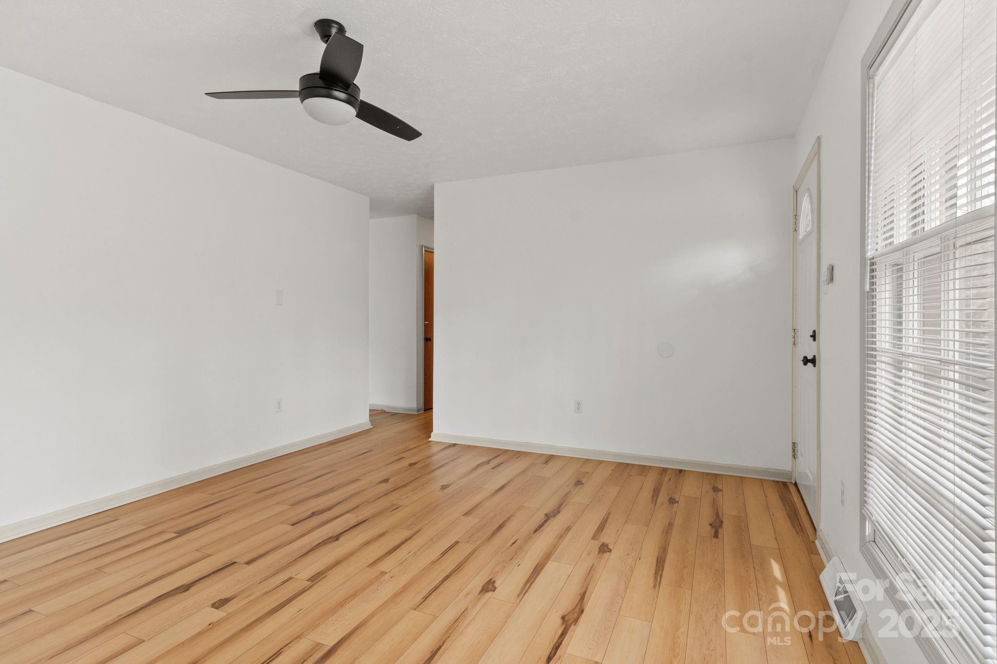 14 South Ridge Place Arden, NC 28704 - Photo 6 of 32 a view of empty room with wooden floor and fan