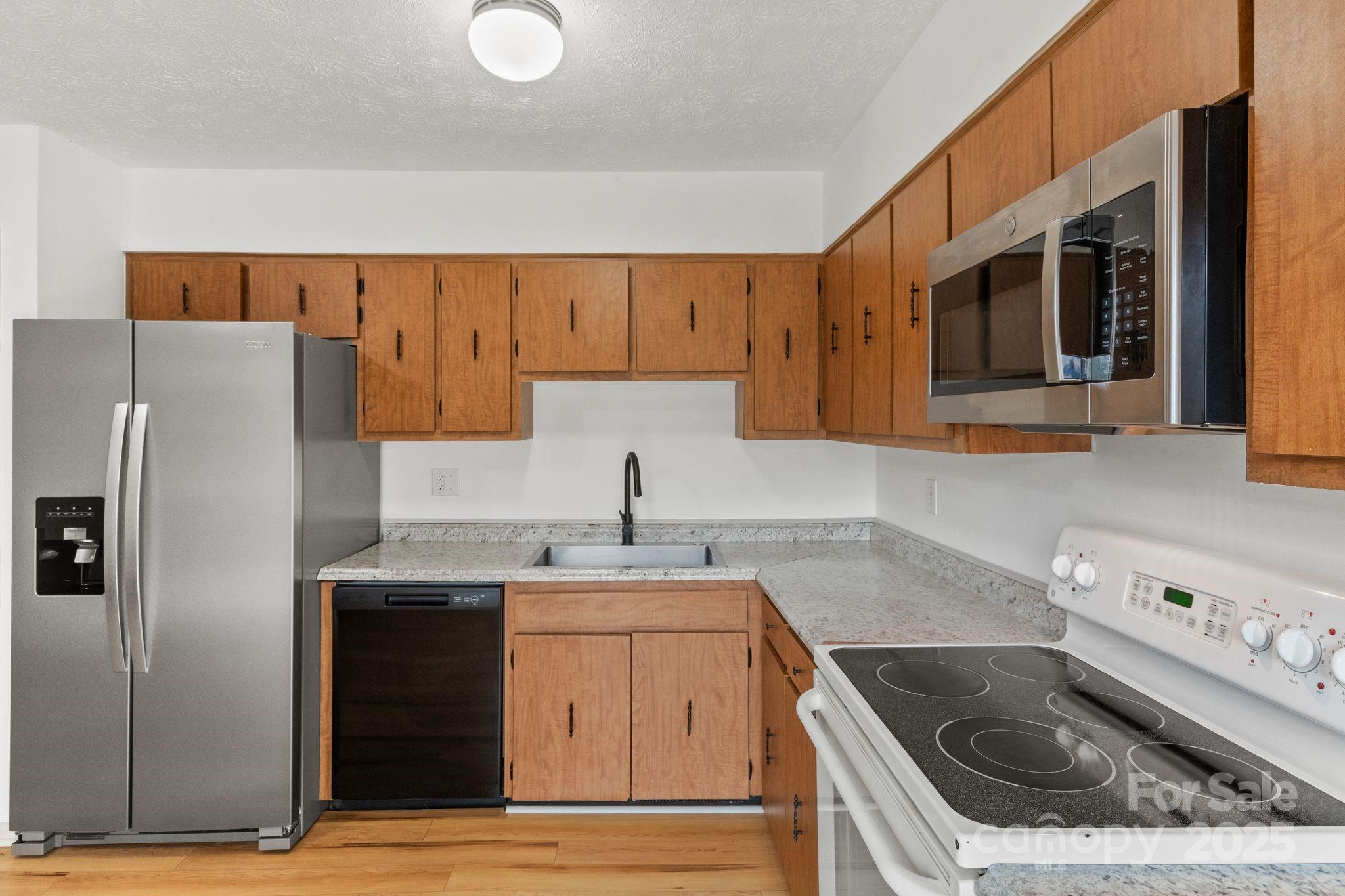 14 South Ridge Place Arden, NC 28704 - Photo 7 of 32 a kitchen with a sink stove and refrigerator