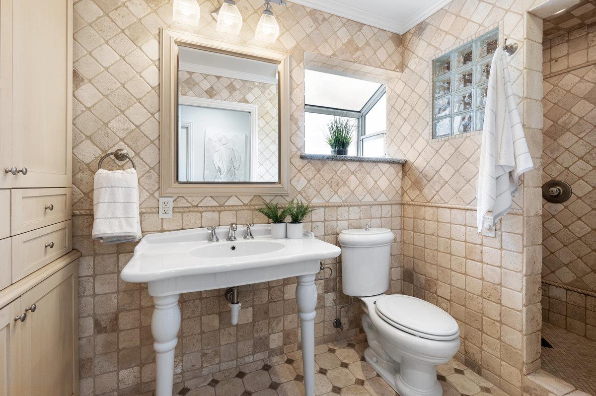 3524 Michael Drive San Mateo, CA 94403 - Photo 22 of 39 a bathroom with a sink a toilet and mirror